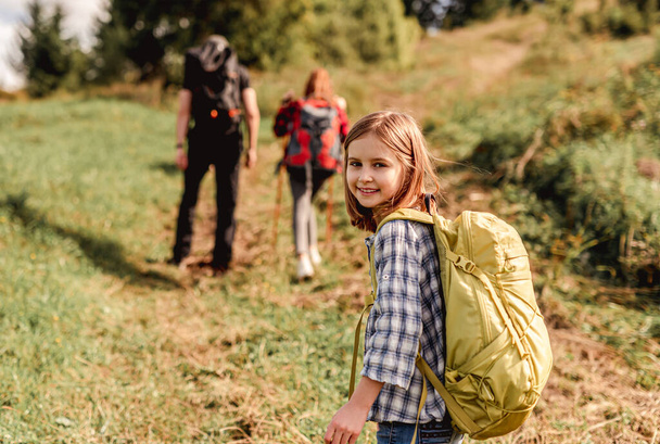 Smiling little girl trekking in mountains - Fotografie, Obrázek