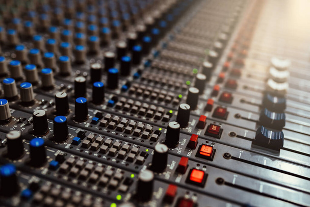 Professional audio mixing console with faders and adjusting knobs - Fotografie, Obrázek