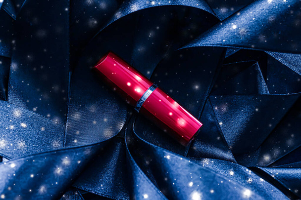 Red lipstick on blue silk and shiny glitter background, luxury make-up and beauty cosmetic - Foto, imagen