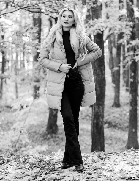 Outfit prove puffer coat can look stylish. Girl fashionable blonde walk in park. Jackets everyone should have. Best puffer coats to buy. How to rock puffer jacket like star. Puffer fashion concept - Foto, Imagem