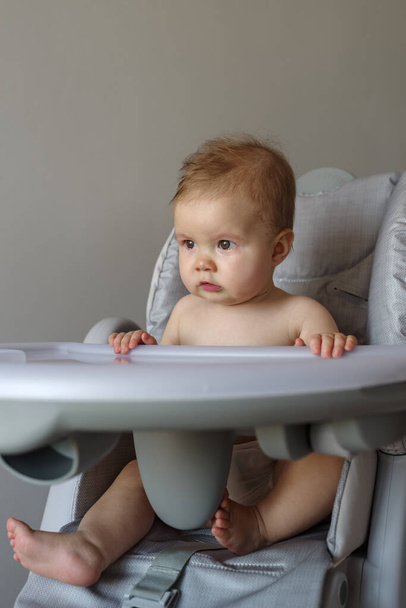 Chorando bebê menina sentada em sua cadeira alta - Foto, Imagem