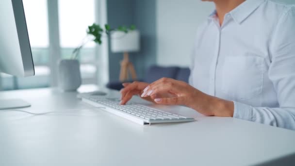 Mujer con gafas escribiendo en el teclado de un ordenador. Concepto de trabajo remoto. - Metraje, vídeo