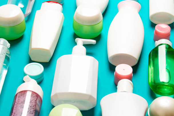Top view of different cosmetic bottles and container for cosmetics on colored background. Flat lay composition with copy space. - Fotó, kép