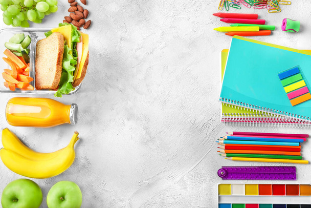 Healthy school lunch and various school stationery on white background. Top view. Copy space. - Foto, immagini