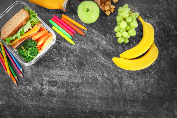 Healthy school lunch on black chalkboard background. Top view. Copy space. - Zdjęcie, obraz