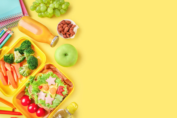 Healthy school lunch box and school stationery on yellow background. Copy space. - Fotó, kép