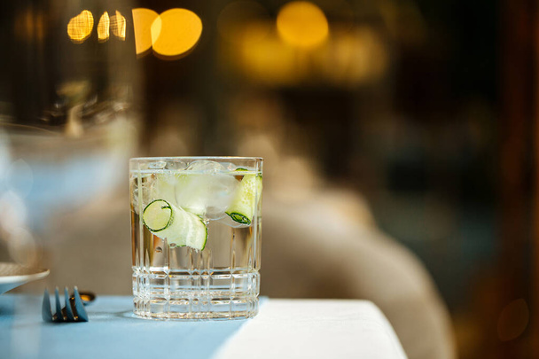 Glass of beverage with ice and cucumber  - Photo, Image