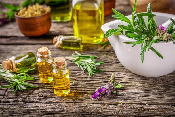 Herbal medicine. Healing herbs and essential oil in vintage, rustic style on wooden background. - Foto, Bild