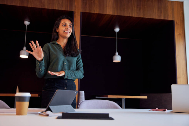 Businesswoman With Digital Tablet Giving Presentation In Modern Open Plan Office - Фото, зображення