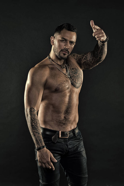 brutal and sexy. muscular bodybuilder with body tattoo. athletic male show six packs on torso. fitness model topless. healthcare lifestyle. body strong abs. Wild masculine beauty. macho - Fotografie, Obrázek