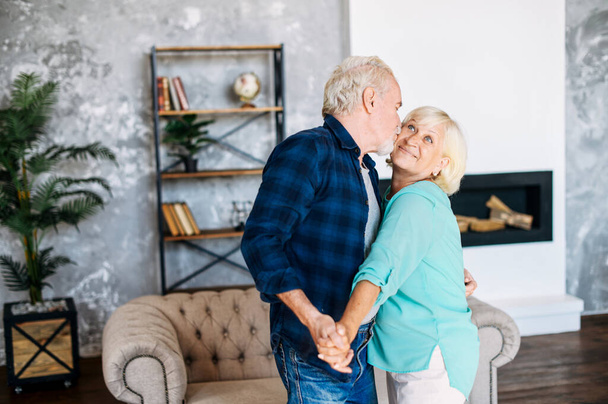 Romantic modern senior couple hagging indoors - Photo, image