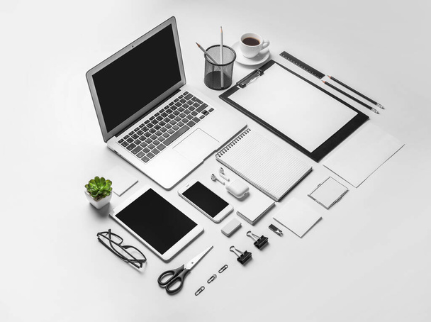 Серый стильный офисный стол с корпоративными канцелярскими принадлежностями. - Фото, изображение