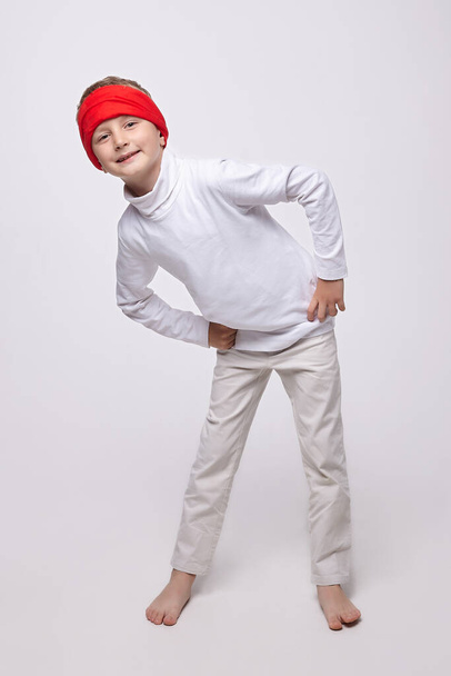 young boy in a headband in the studio on a white background - 写真・画像