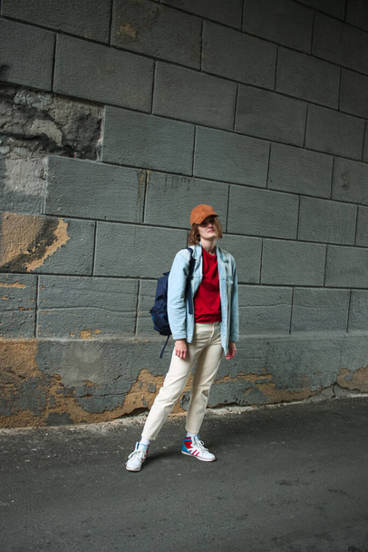Girl tomboy photo in full growth. Street fashion. Relaxed postur - Fotó, kép