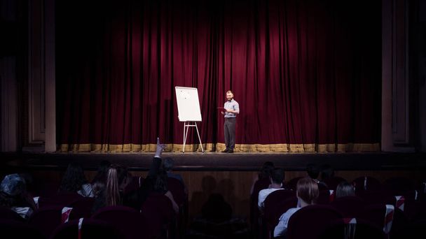 Male caucasian speaker giving presentation in hall at university or business centre workshop - Zdjęcie, obraz