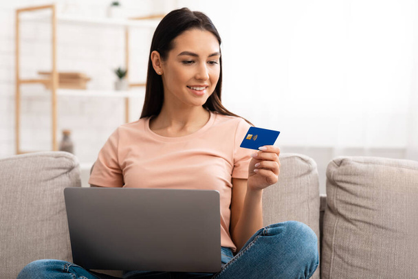 Young woman making purchases sitting on the couch - Photo, Image