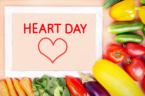 Fresh organic vegetables and frame with text, HEART DAY.  Fresh food for a healthy heart concept. - Foto, afbeelding