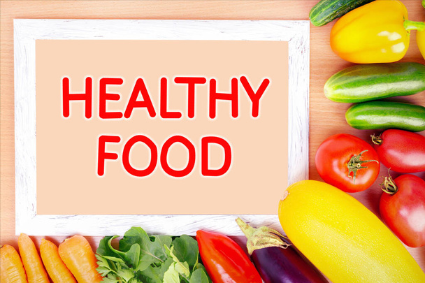 Healthy food concept. Assorted vegetables and frame on wooden surface. - Fotografie, Obrázek