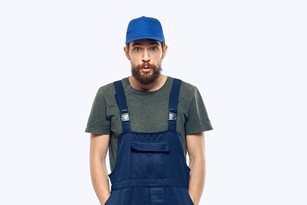 Worker man uniform delivery service emotions studio light background - 写真・画像