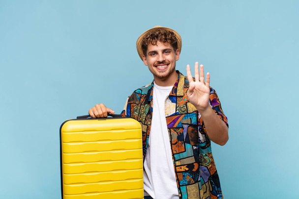 young man smiling and looking friendly, showing number four or fourth with hand forward, counting down. holidays concept - Photo, image