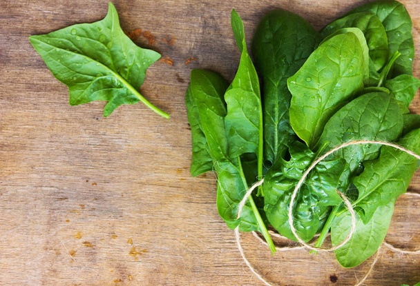 A bunch of fresh spinach on the table - Photo, Image