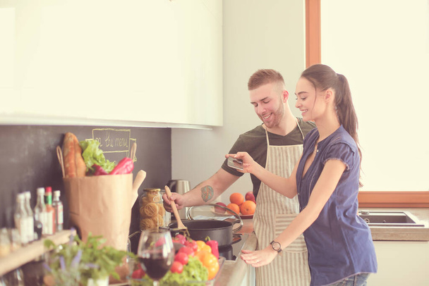 Couple cooking together in their kitchen at home - Foto, immagini