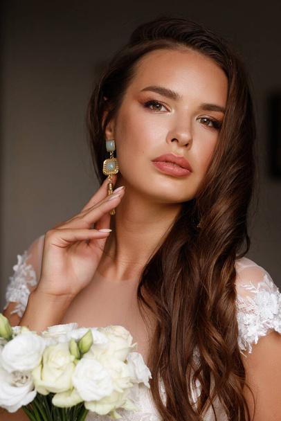 portrait of the bride with a bouquet with makeup and hair. Wedding stylist - Zdjęcie, obraz