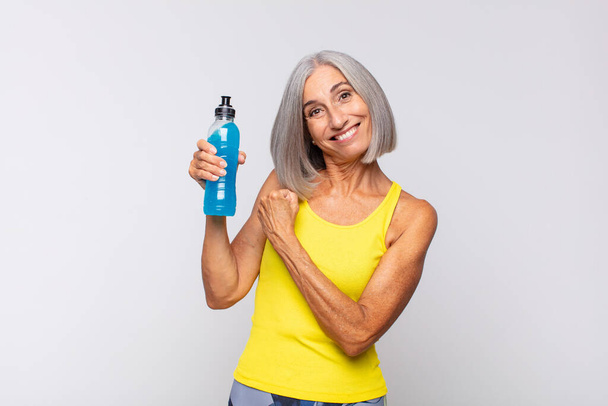 middle age woman feeling happy, positive and successful, motivated when facing a challenge or celebrating good results. fitness concept - Fotoğraf, Görsel