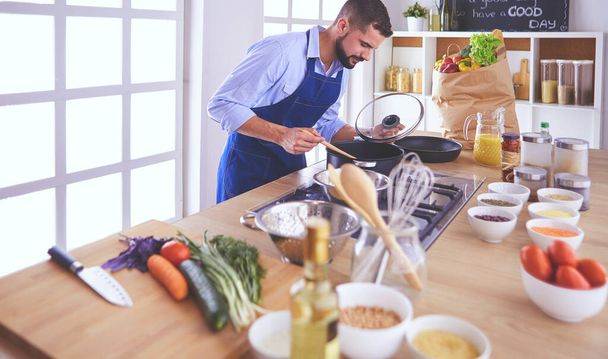 Man preparing delicious and healthy food in the home kitchen - Photo, image