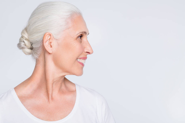 Close-up profile side view portrait of her she nice-looking attractive lovely well-groomed cheerful cheery positive glad gray-haired lady copy space isolated over light white grey pastel background - Foto, Bild