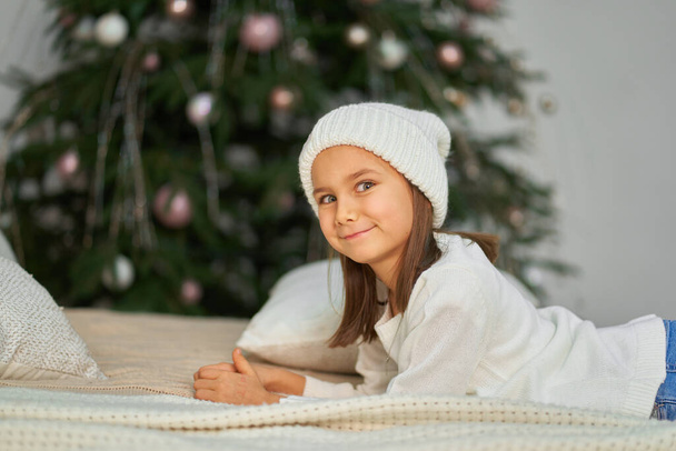Happy childhood, Christmas magic fairy tale. Little girl waiting for Christmas and holiday gifts - Foto, Bild