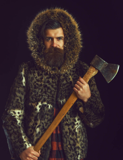 bearded man in fur with axe - Фото, зображення