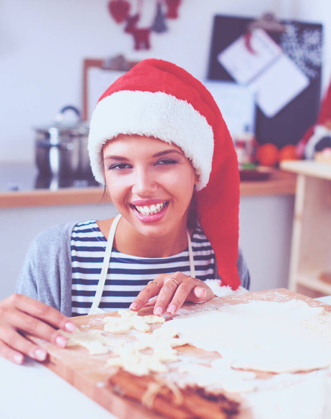 Woman making christmas cookies in the kitchen - Фото, зображення