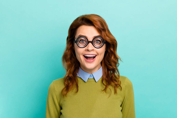 Close-up portrait of her she nice intellectual funny cheerful wavy-haired girl wearing thick glasses cheering good news isolated on bright vivid shine vibrant teal turquoise color background - Foto, afbeelding