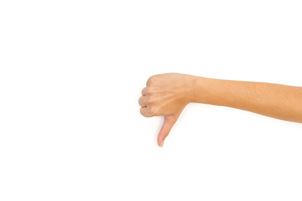 Woman hand with thumb down on a white background with copy space - 写真・画像