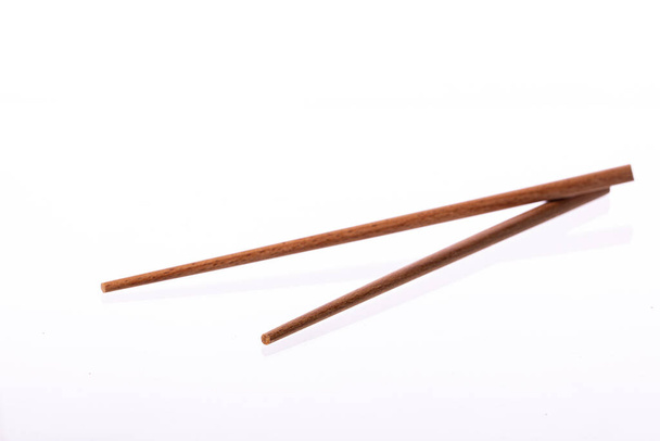 Eco-friendly wooden chopsticks isolated on white background. Reusable utensils - Photo, Image