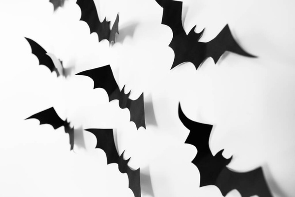 Paper bats decorations on a white background. Halloween concept. Hand made fall decor. Copy space for creative design - Foto, afbeelding