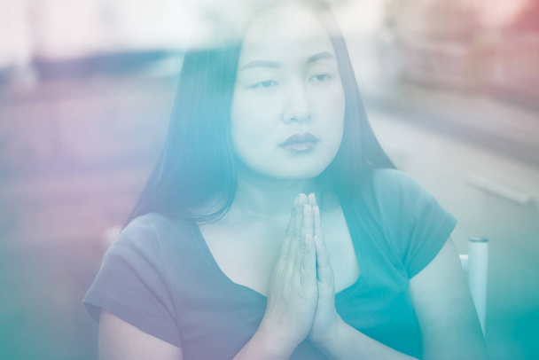 woman praying and worship to GOD Using hands to pray in religious beliefs and worship christian in the church or in general locations in vintage color tone or copy space. - Photo, Image