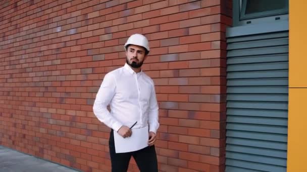 Engineers plan for manufacturing work. Caucasian businessmen in helmets or safety clothing. - Felvétel, videó
