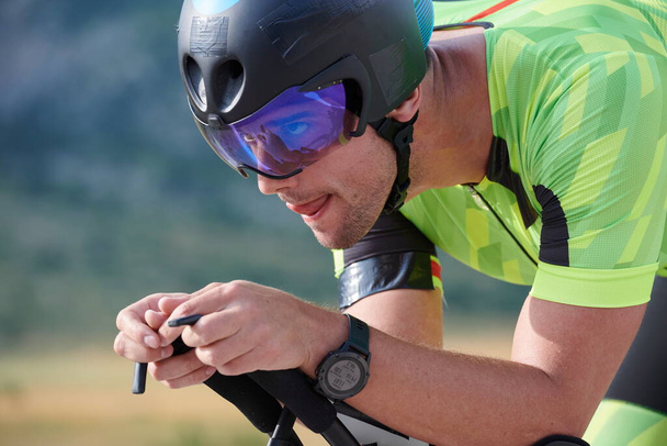 triathlon athlete riding professional racing bike at workout on curvy country road - Zdjęcie, obraz