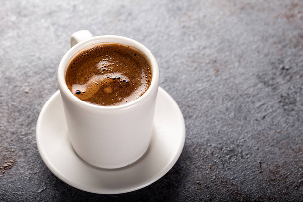 Cup of espresso. Cup of hot coffee on stone background. - Photo, Image