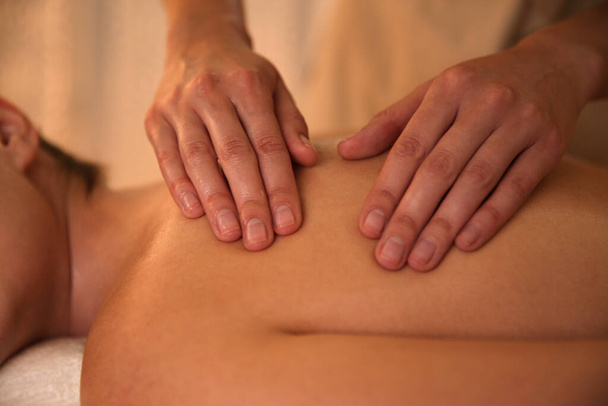 Young woman receiving back massage in spa salon, closeup - Фото, изображение