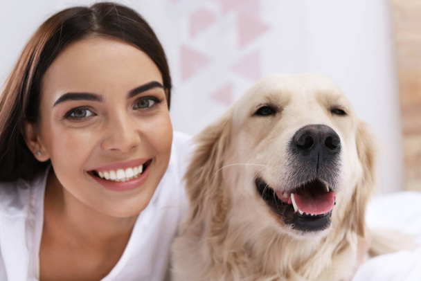 Happy woman with her cute pet dog at home - Foto, Imagen