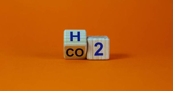 Change to fuel cell vehicles. Fliped cube, changes the expression CO2 to H2. Beautiful orange background. Ecological concept. Copy space. - Foto, afbeelding