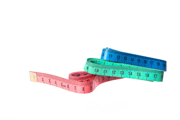 Three measuring tapes isolated on white background. Sewing, clothing repair - Photo, Image