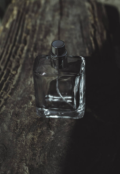 Male perfume bottle on an old wooden background. - Photo, Image
