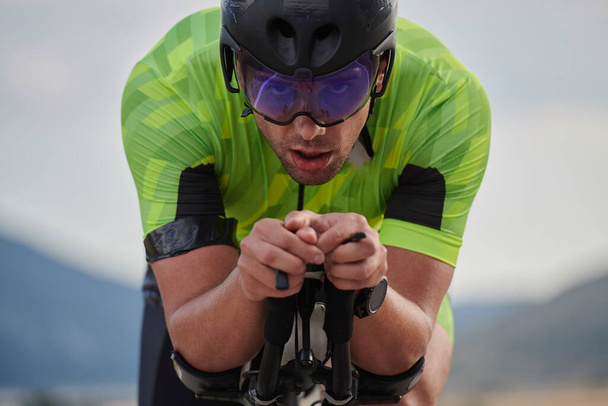 closeu of triathlon athlete riding professional racing bike at workout - Photo, image