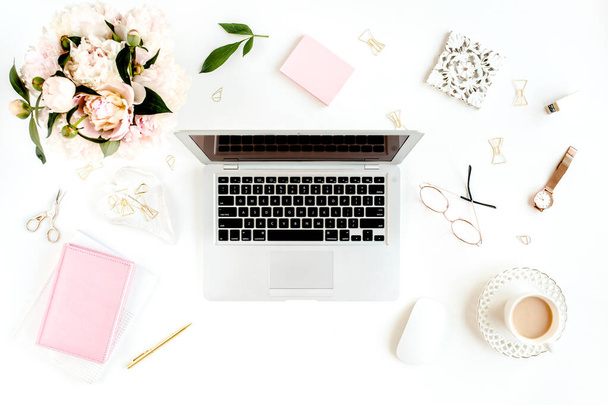 Flat lay womens office desk. Female workspace with laptop, pink peonies bouquet, accessories on white background. Top view feminine background. - Photo, Image