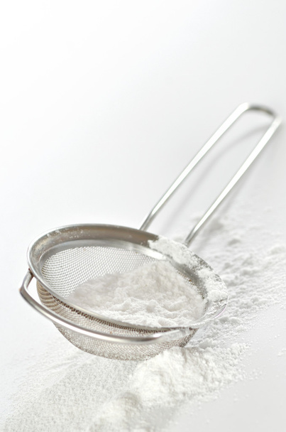 powdered sugar in a metal strainer - Fotoğraf, Görsel
