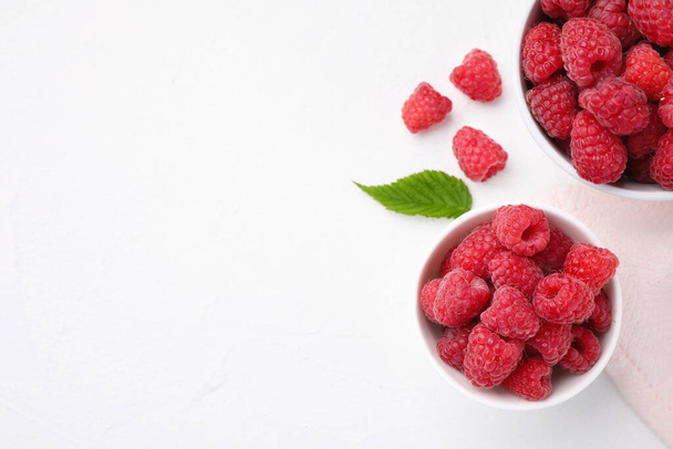 Delicious fresh ripe raspberries on white table, flat lay. Space for text - Photo, image